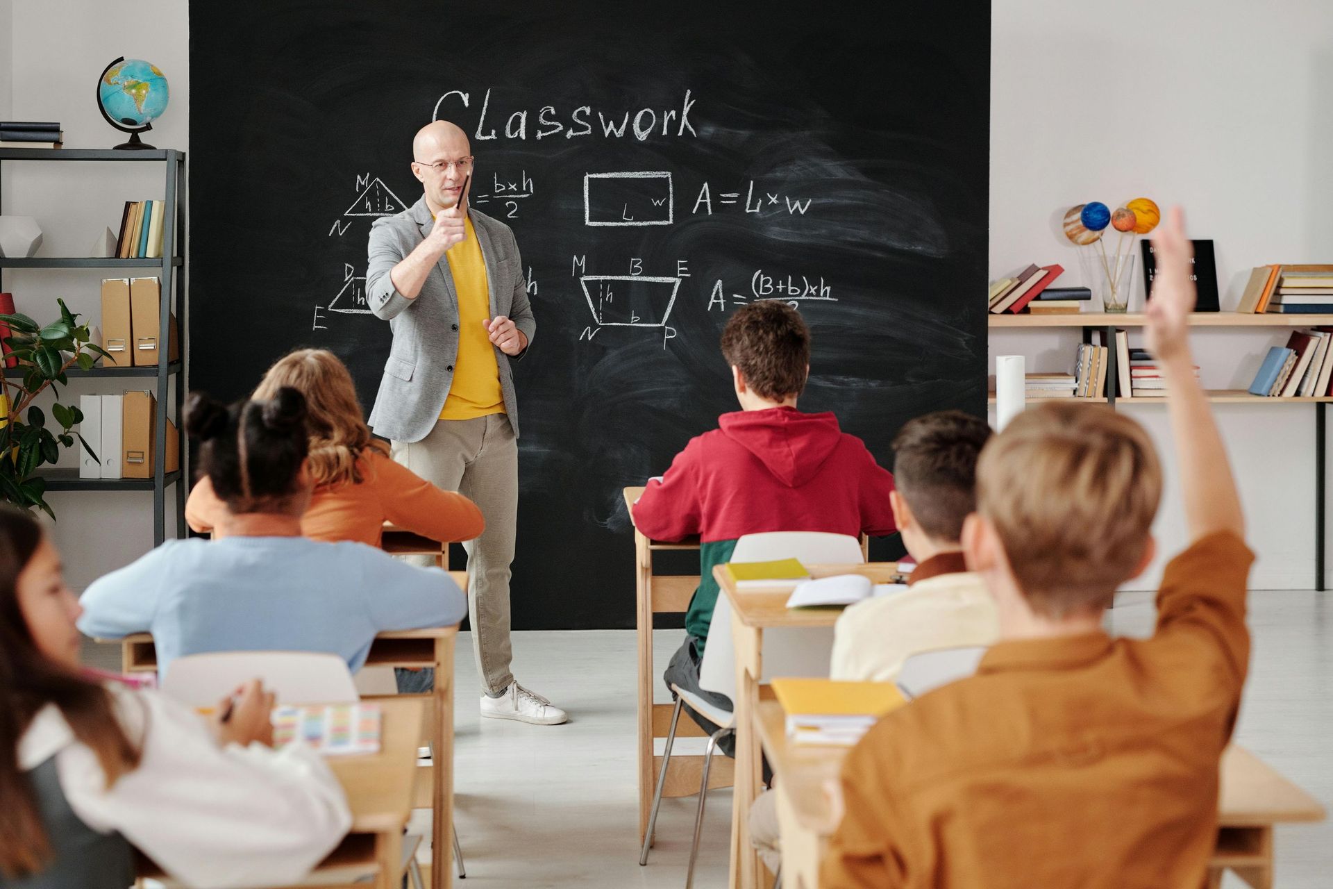 male teacher infront of class: brokers help teachers with home loans in Brisbane.