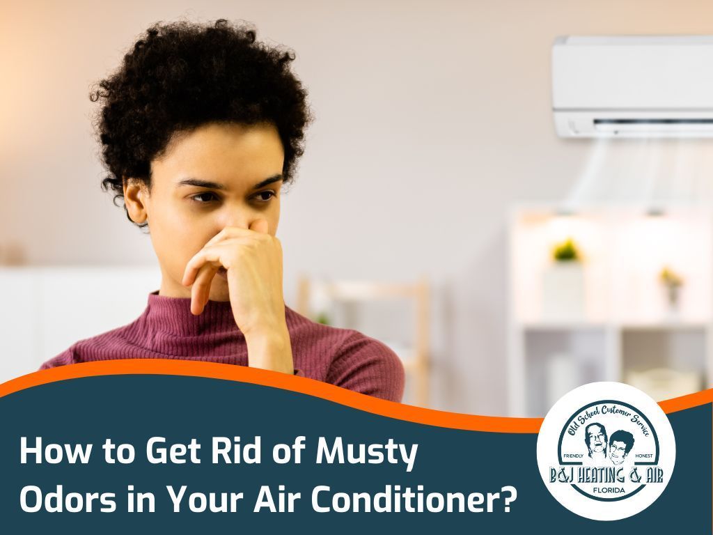 A woman is covering her nose in front of an air conditioner.