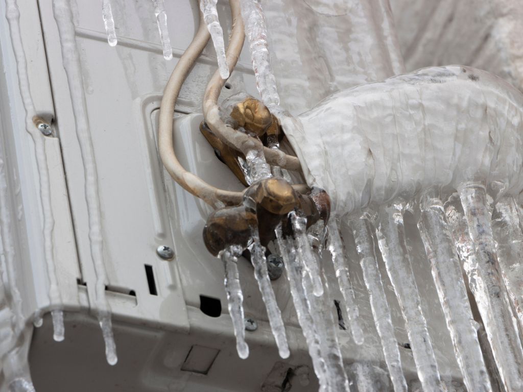 Icicles are hanging from the ceiling of an air conditioner