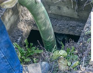Worker Emptying Septic - Septic Services in Cody, WY