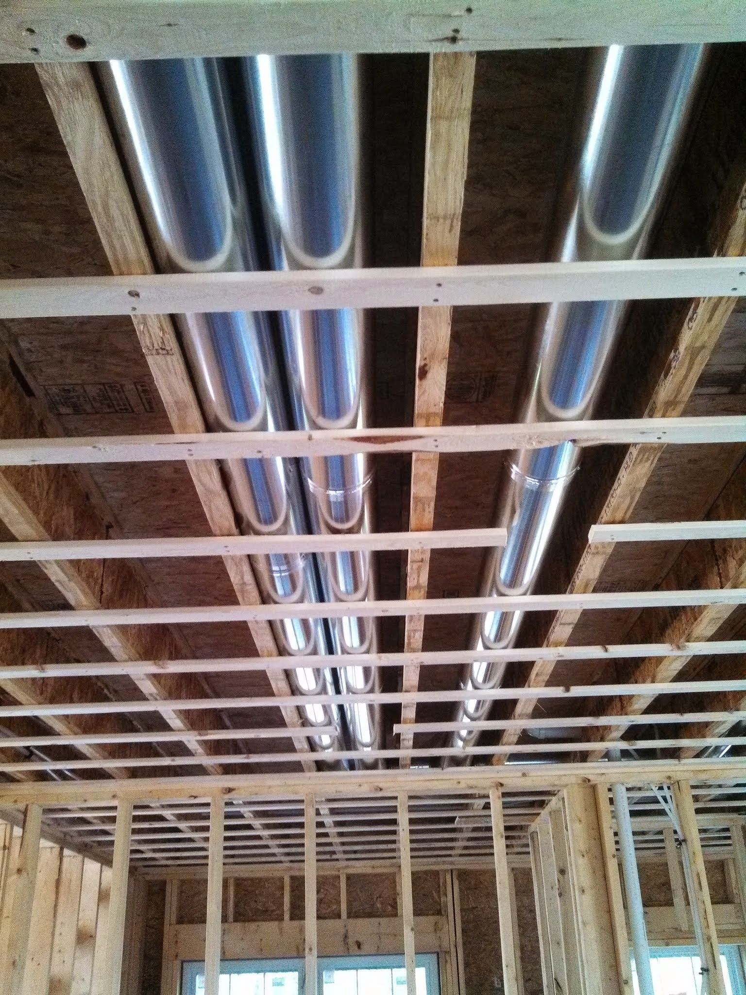 A ceiling with a lot of pipes going through it