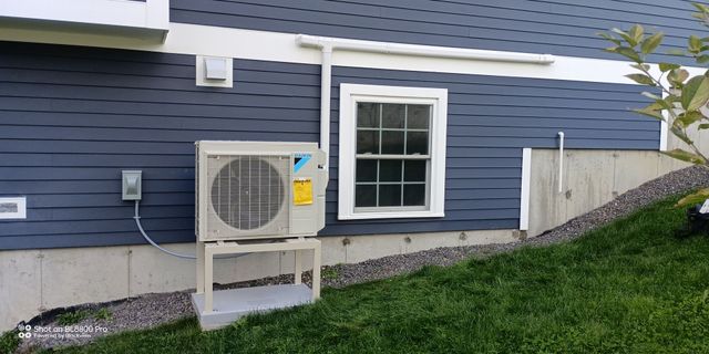 A large air conditioner is sitting on top of a roof.