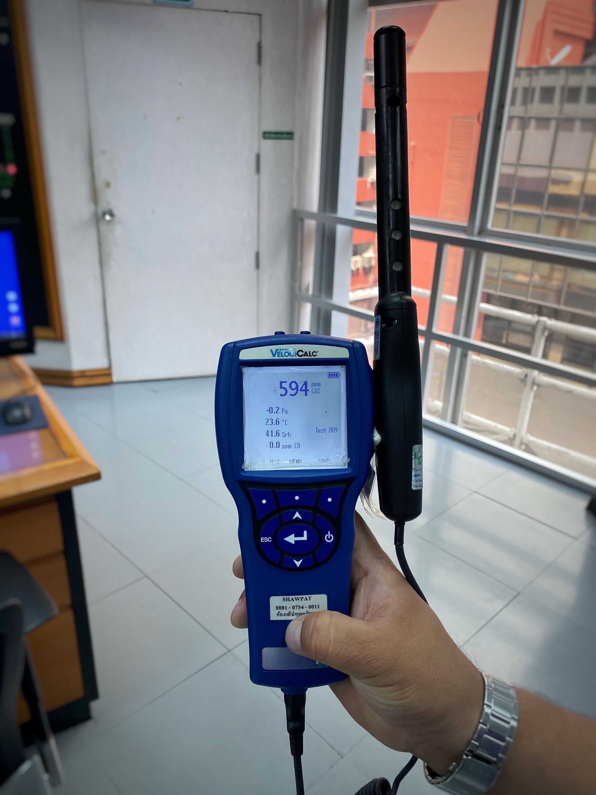 A person is holding a device that says 5481 on the screen