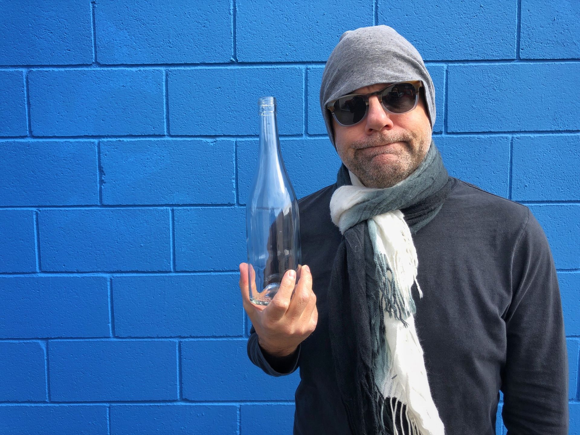 man with empty bottle of wine