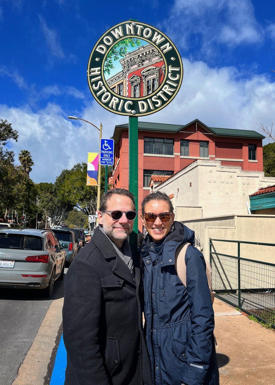 couple in front of downtown sign