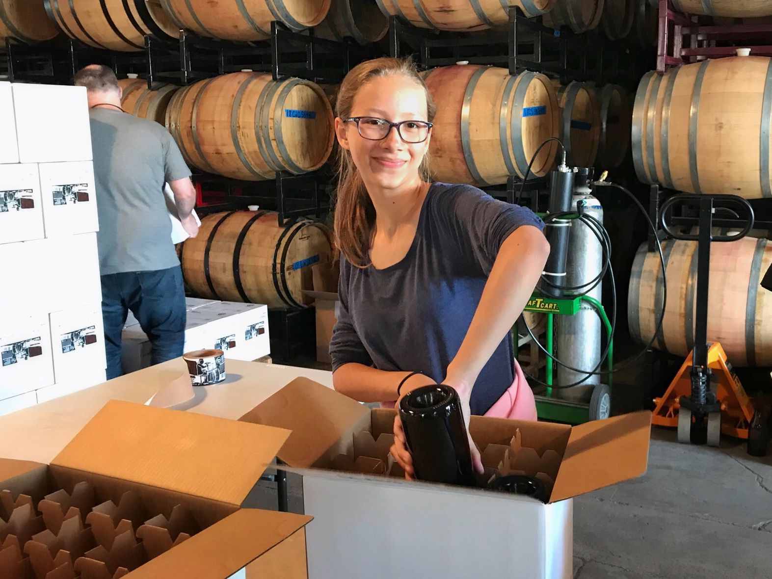 girl packing wine boxes