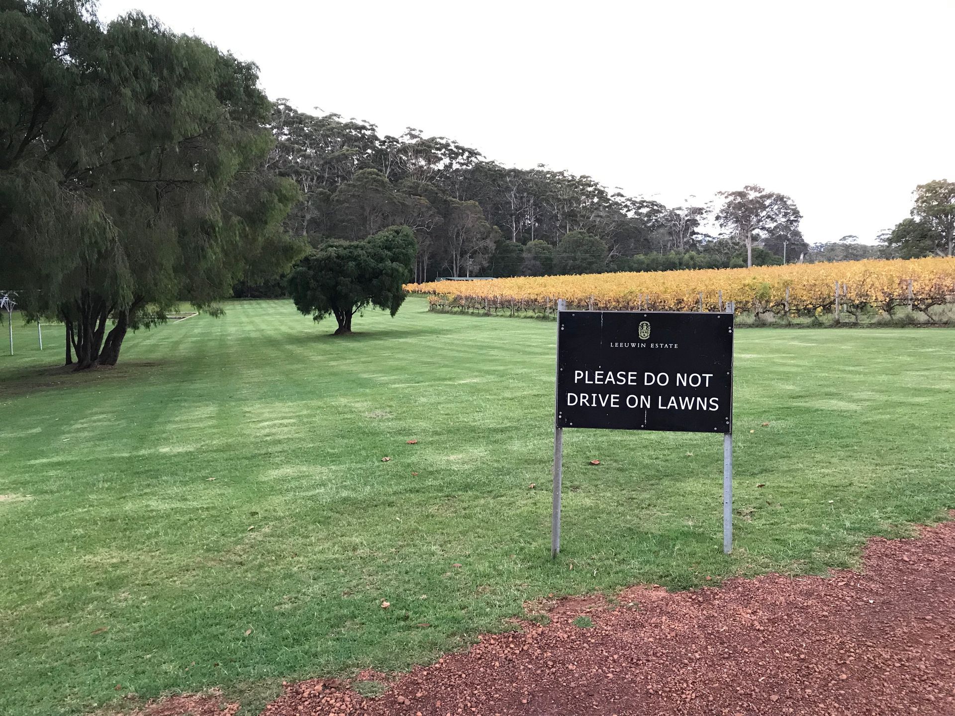 do not drive on grass sign