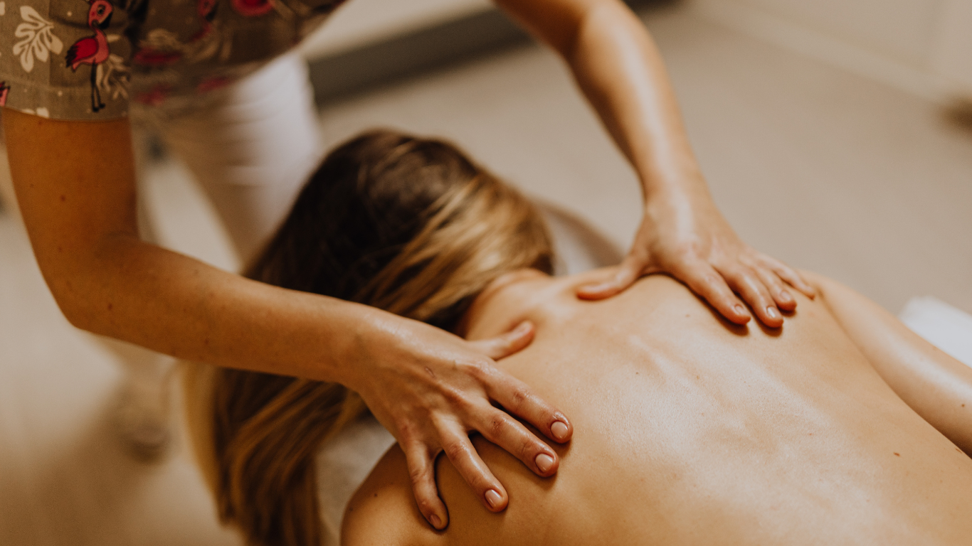 A person receiving a back massage at a spa.