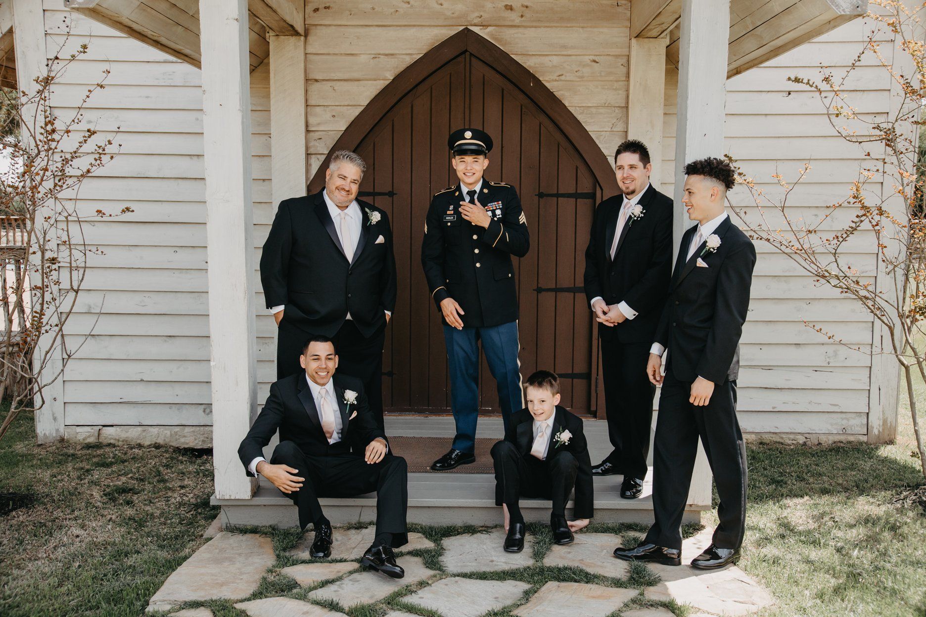 Groom with Grooms Men in front of Chapel door wedding venue Austin