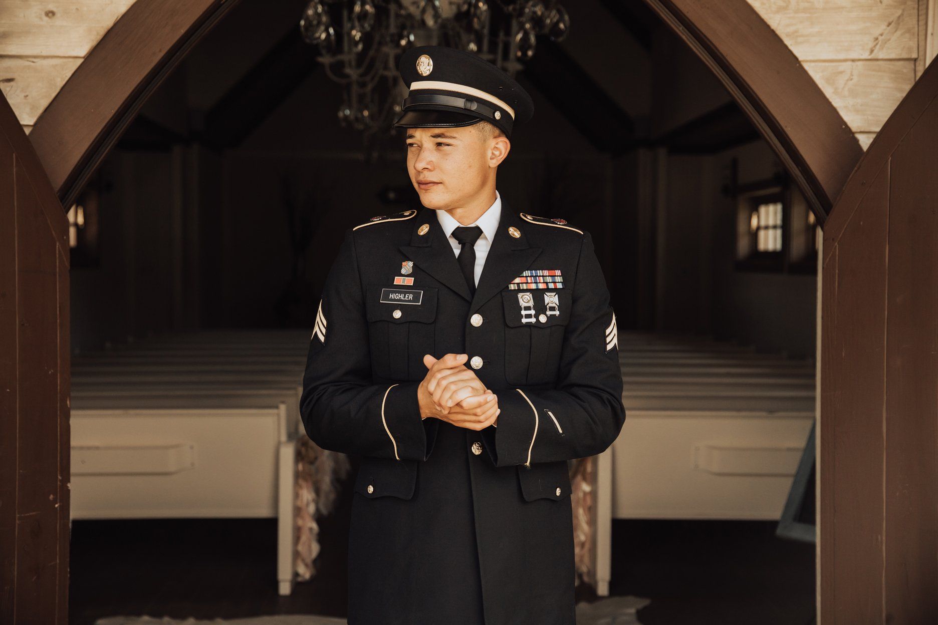 Groom in front of chapel door - Austin Chic Weddings