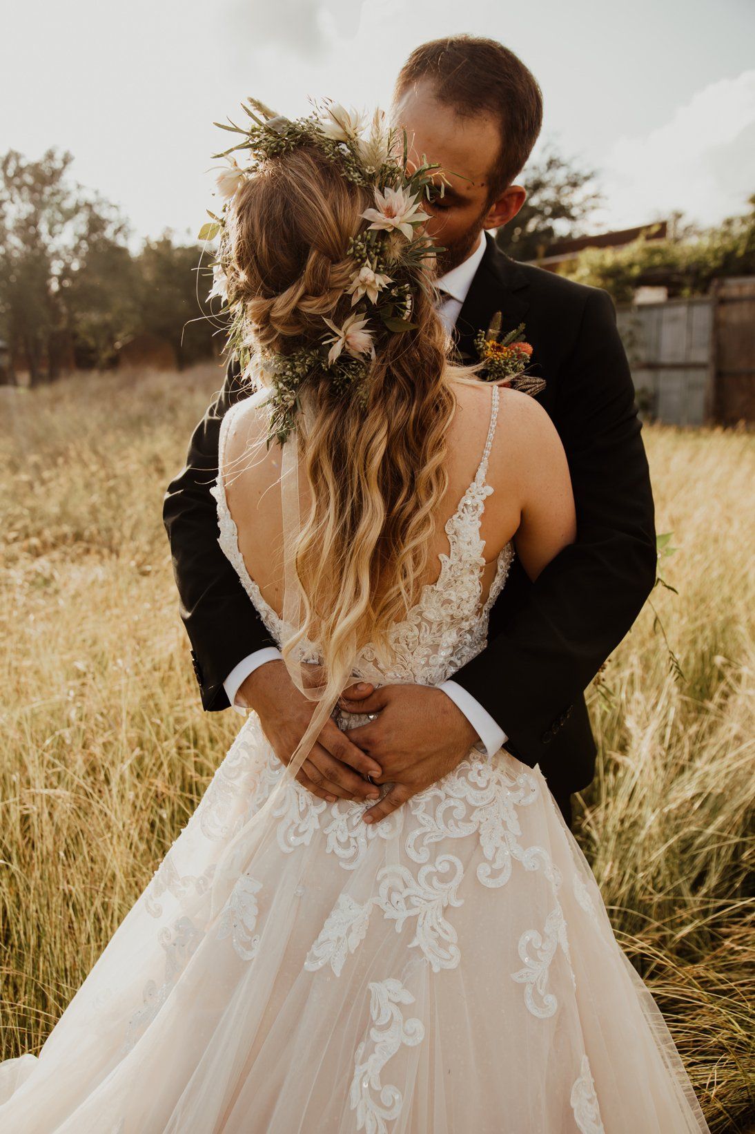 Bride Back - Groom Embrace - Outdoor Wedding - Austin