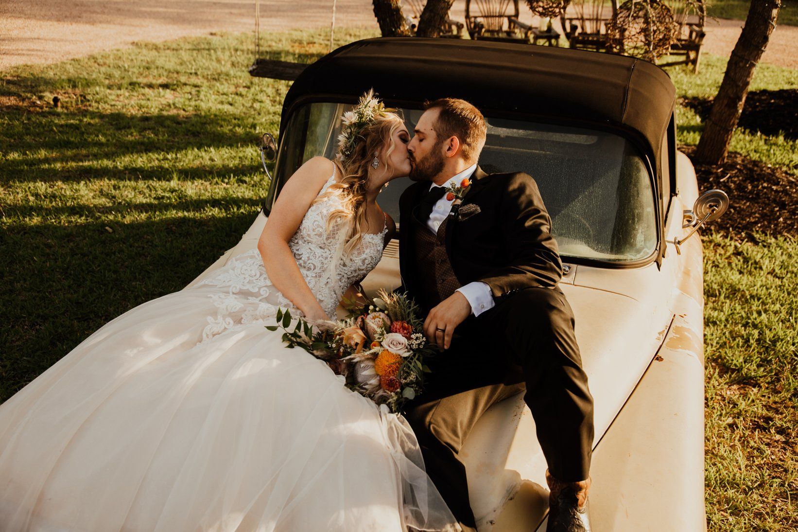 Bride and Groom Kiss on 57 Convertible Chevy - Outdoor Fantasy Wedding - Love - Austin Wedding Location