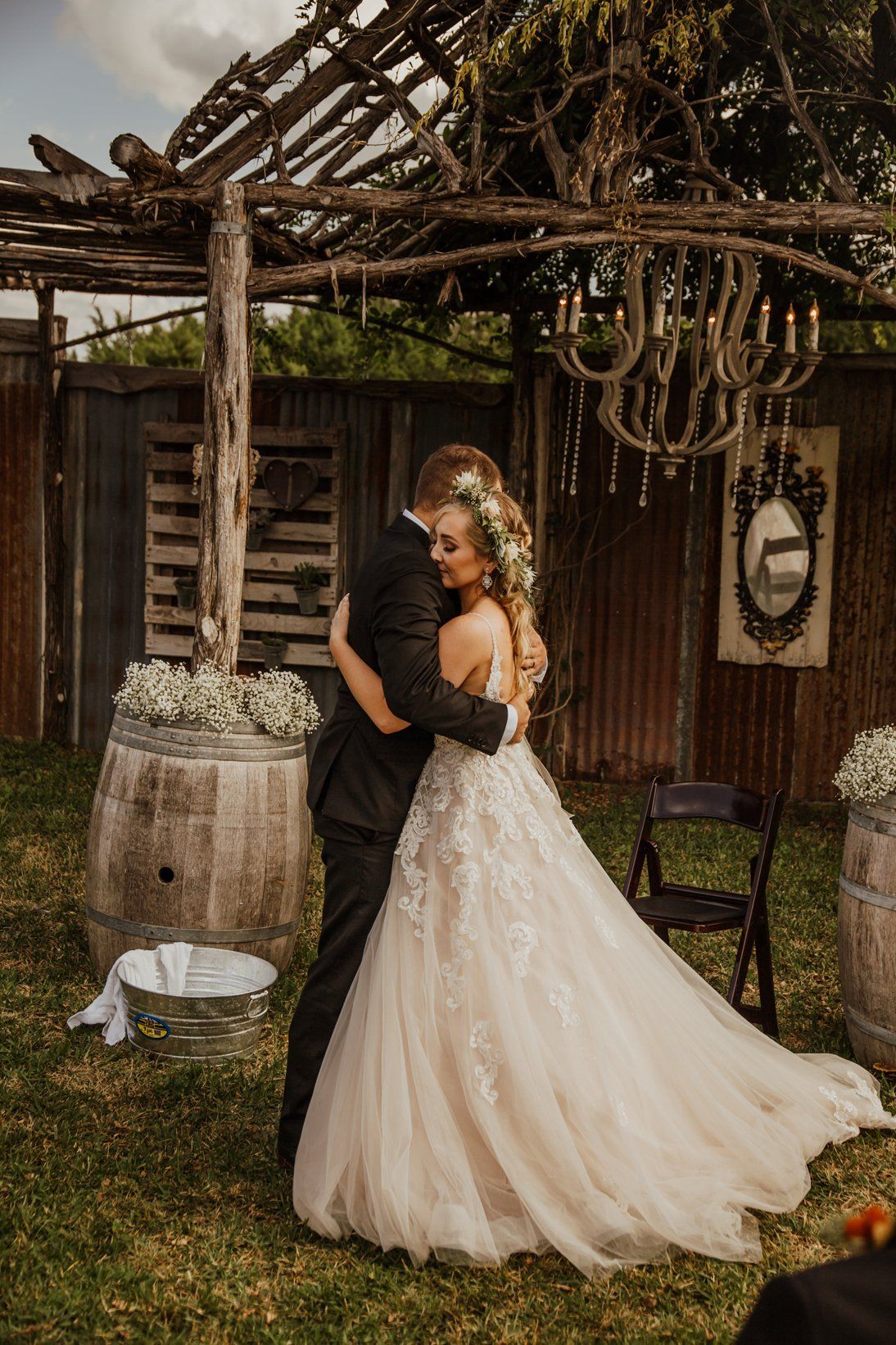 Groom Embraces Bride after Foot Cleaning Ceremony - Outdoor Shabby Chic Crystal Wedding  - Austin