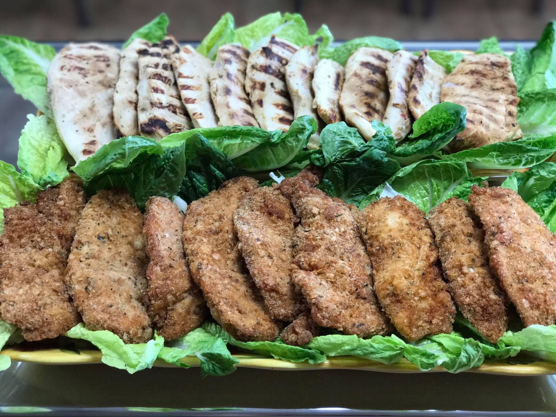 A white plate topped with a variety of sandwiches and fruit.