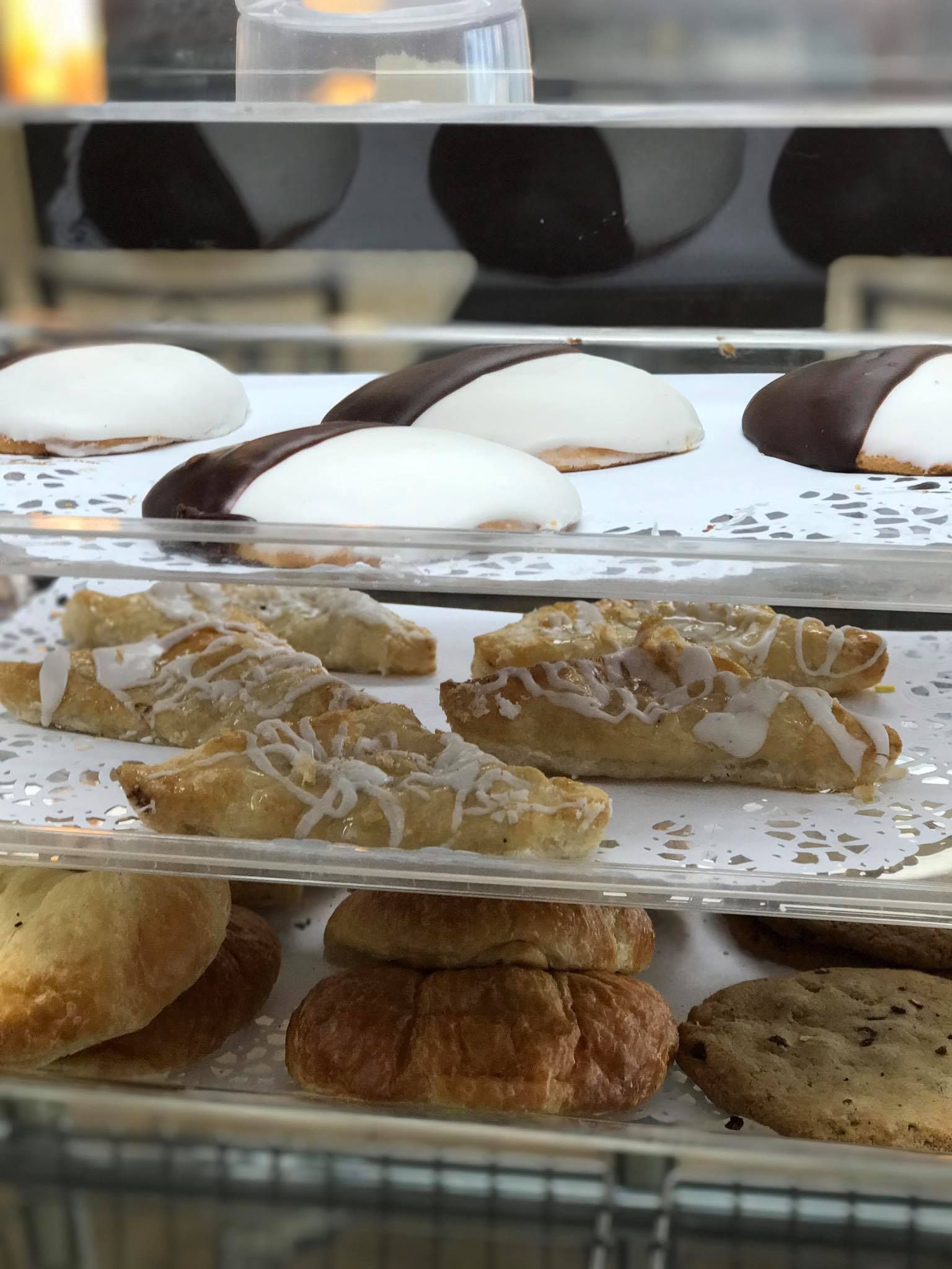 A display case filled with a variety of pastries and cookies.