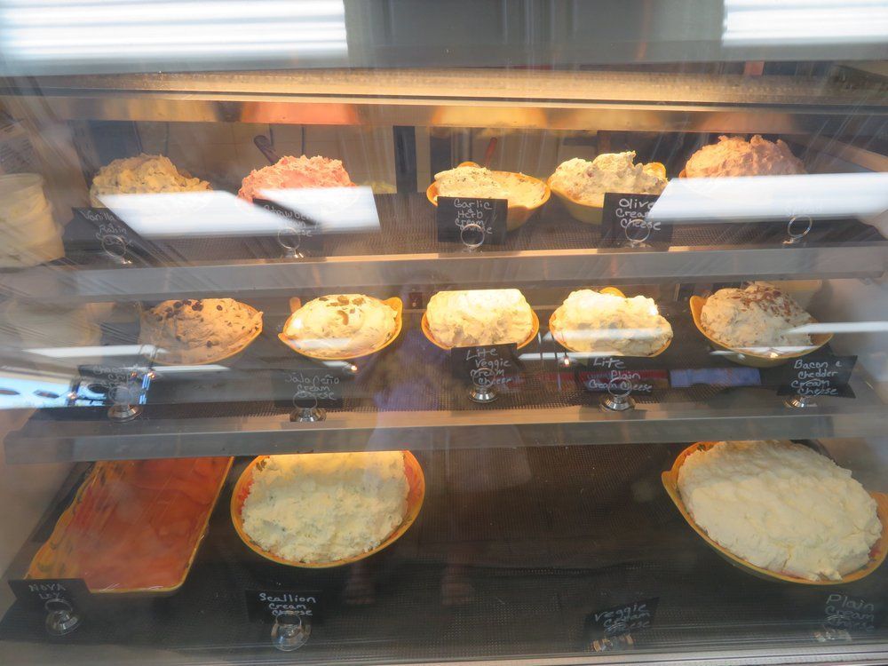 A display case filled with a variety of pies and pastries.