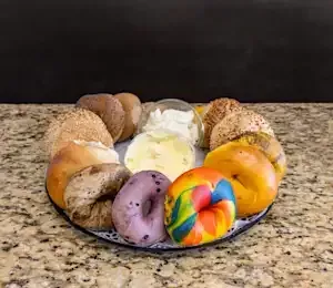 There are many different types of bagels on the plate.