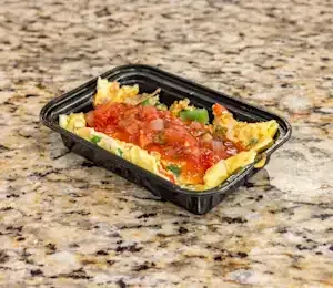 A black plastic container filled with food is sitting on a granite counter.