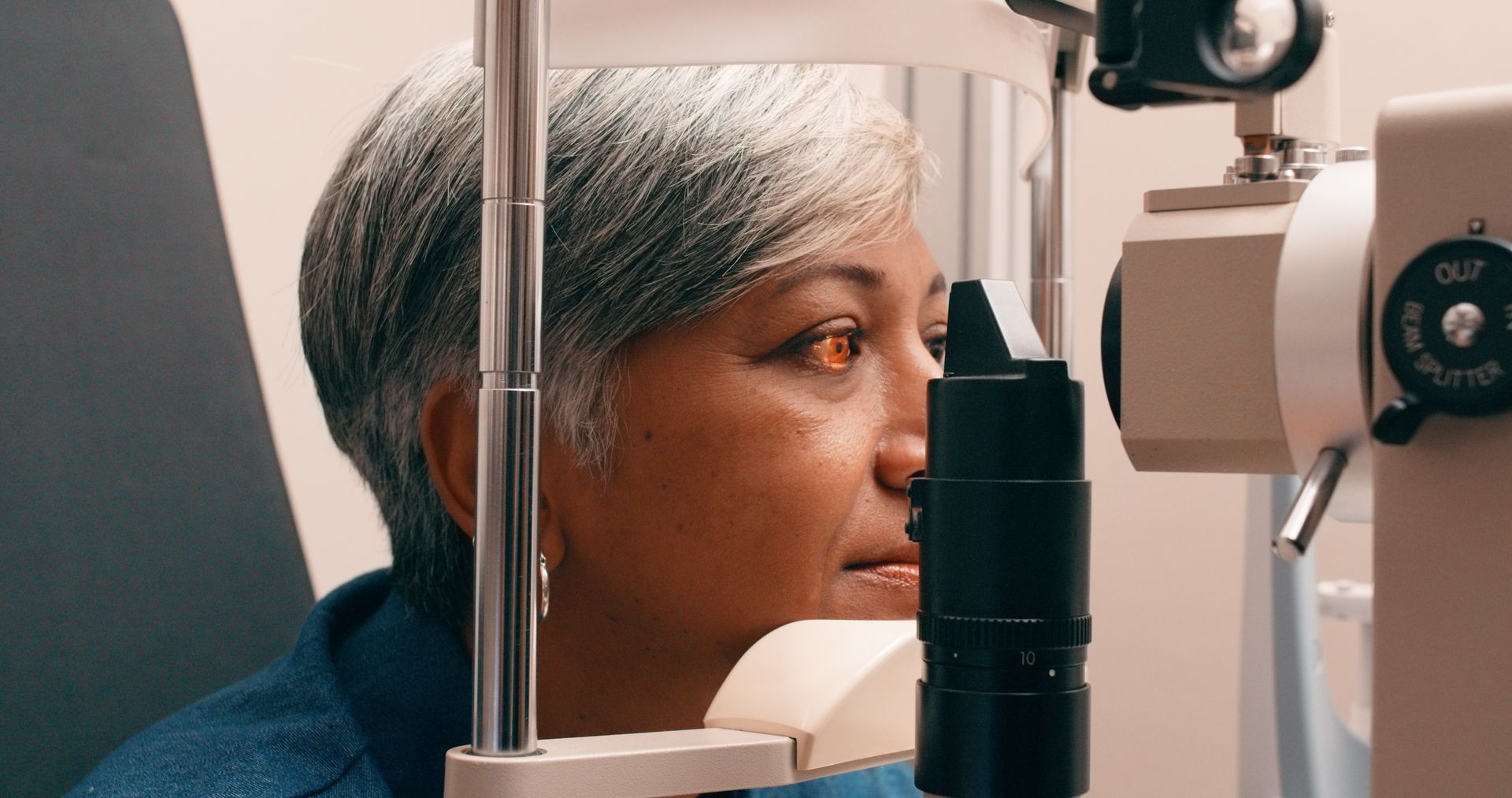 A woman is getting her eyes examined by an ophthalmologist.