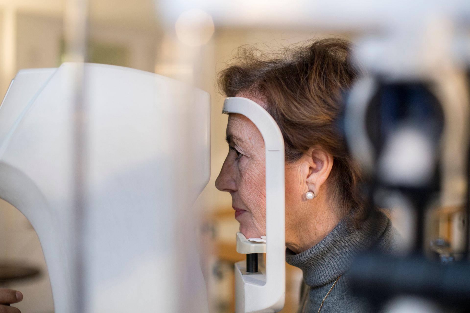 A woman is getting her eyes checked by an ophthalmologist.