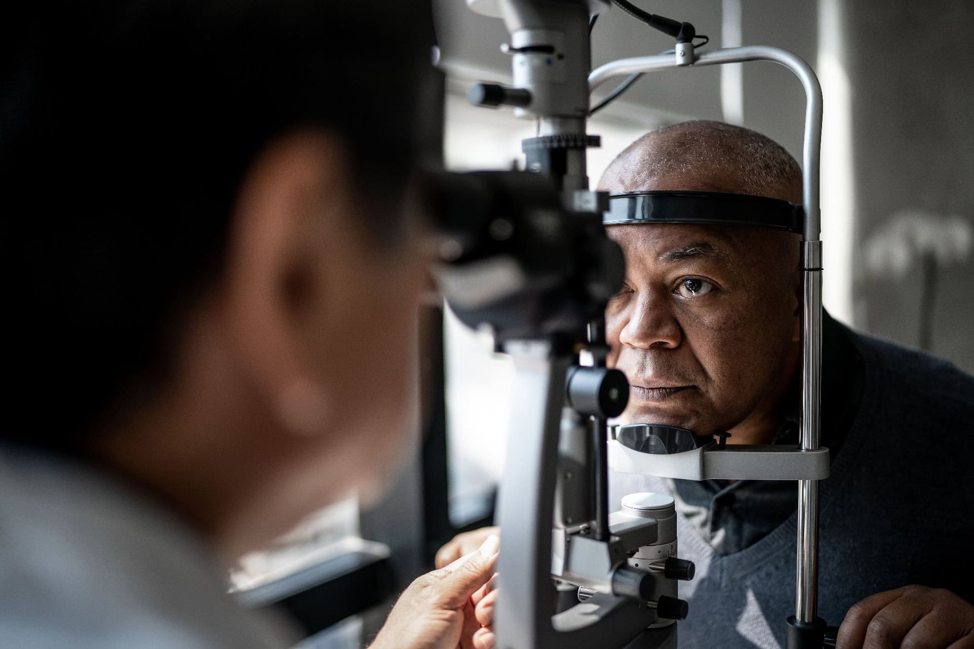 A man is getting his eyes examined by an ophthalmologist.