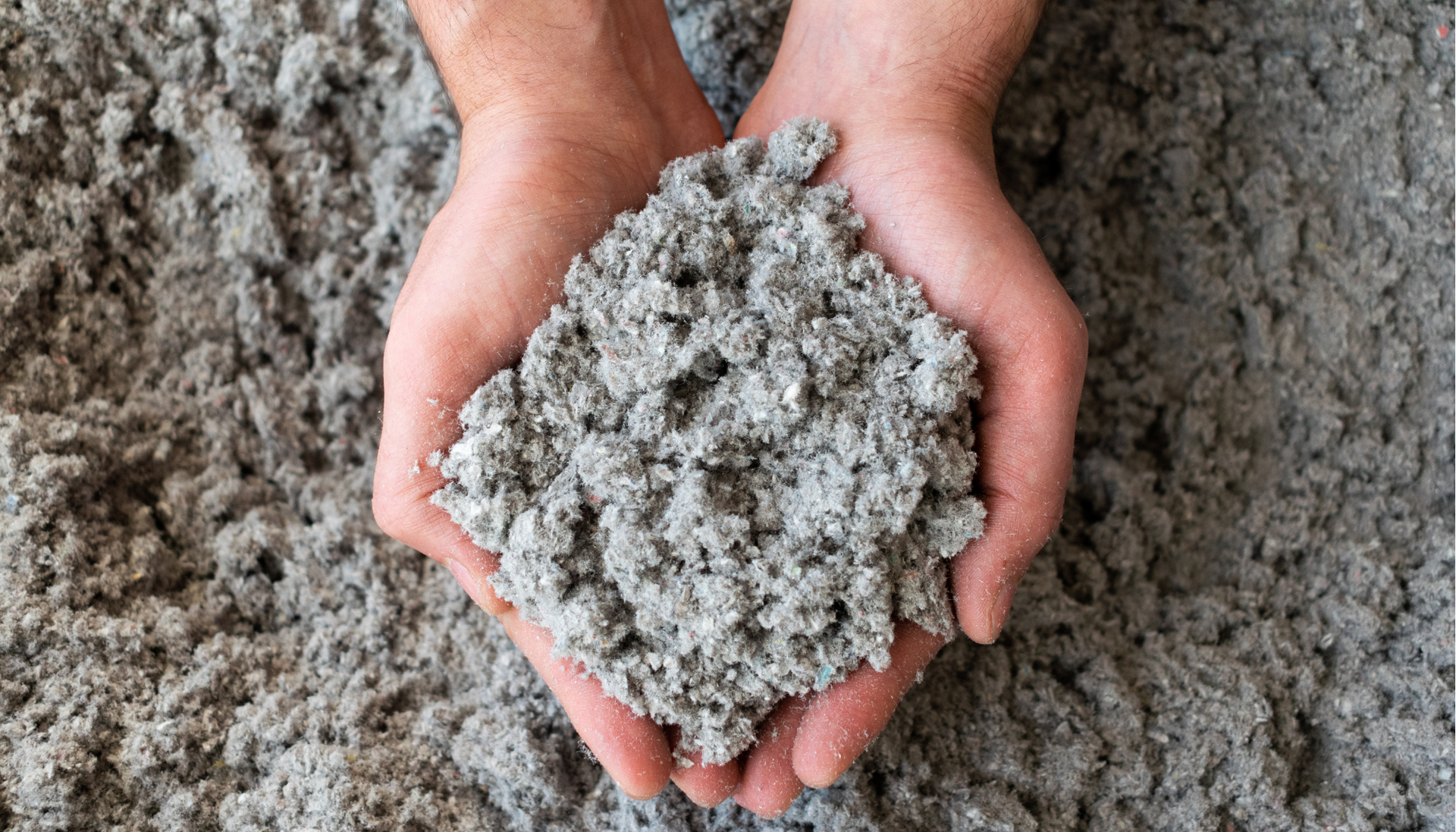 A person is holding a pile of concrete in their hands.