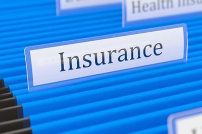 The word insurance is on a blue file folder.