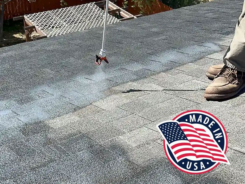 A person is spraying a roof with a made in the usa logo.