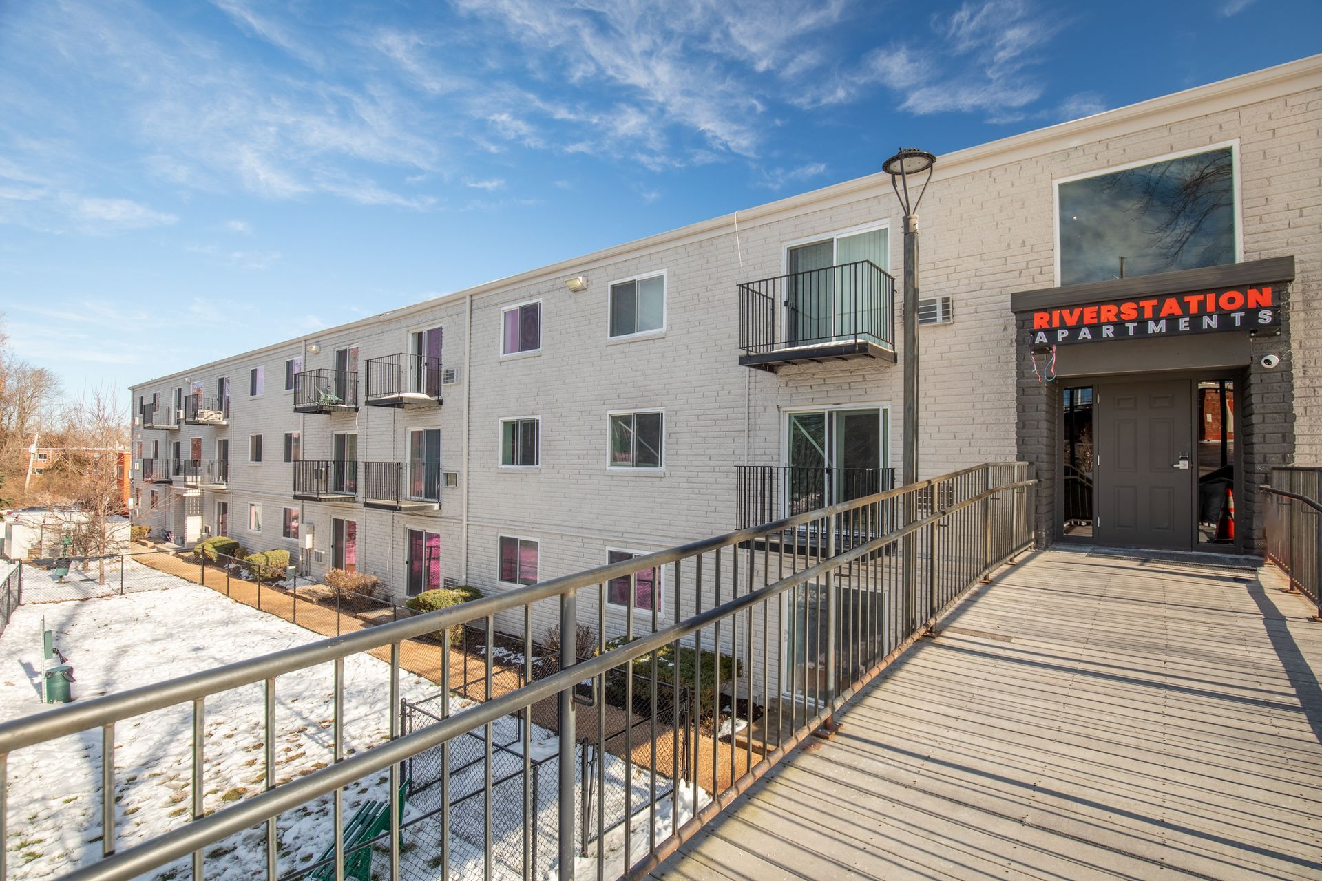 There is a bridge leading to the entrance of the building.