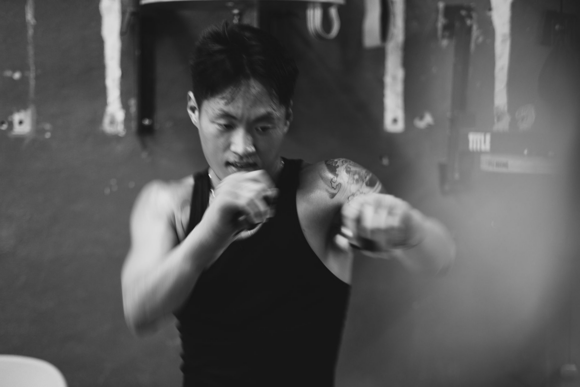 Two men are standing in a boxing ring talking to each other.