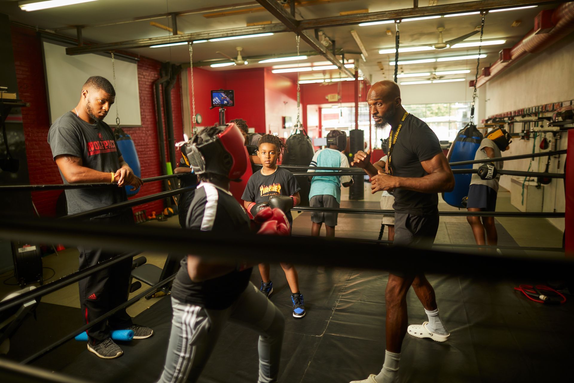 A group of people are boxing in a boxing ring.