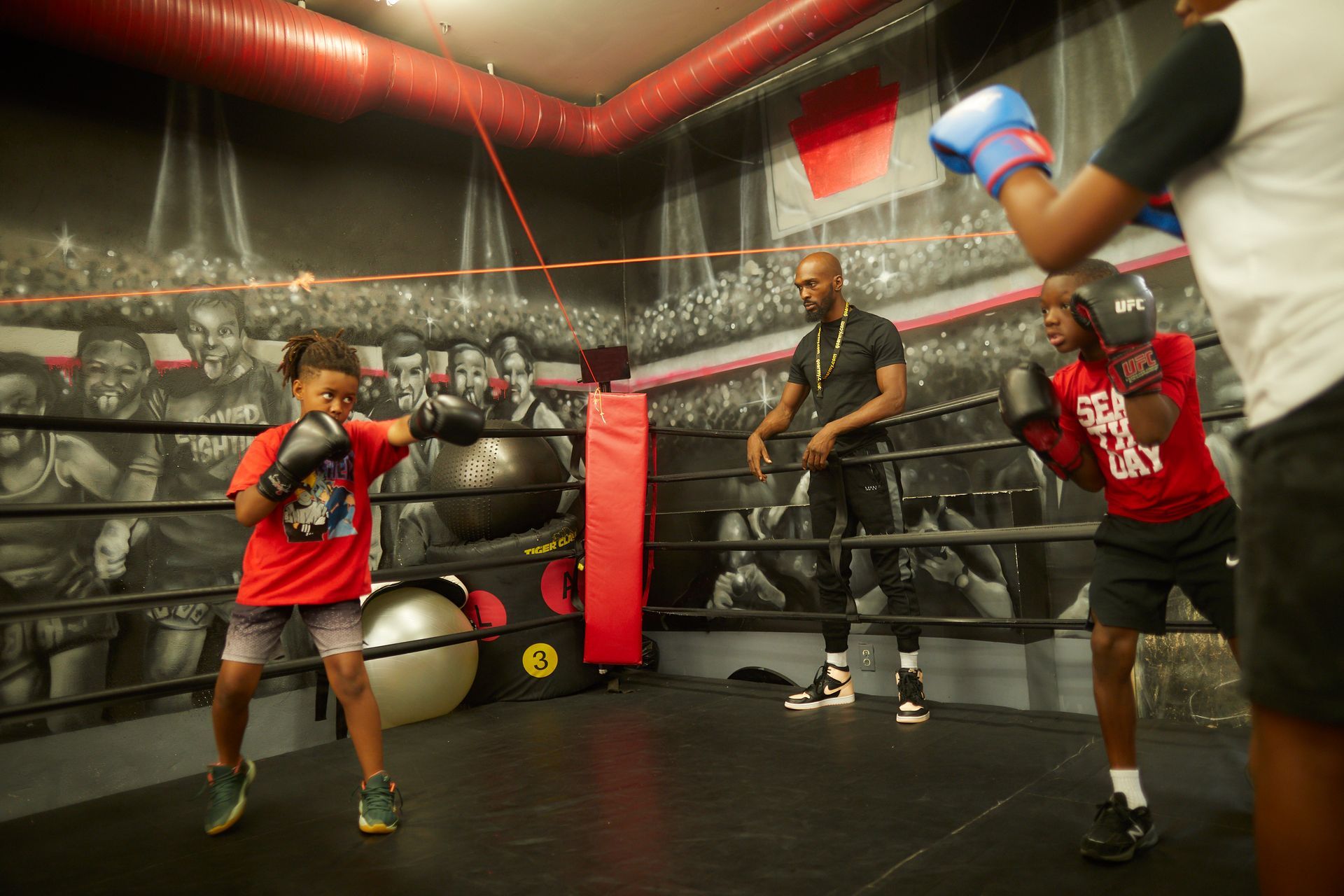 A group of people are boxing in a boxing ring.