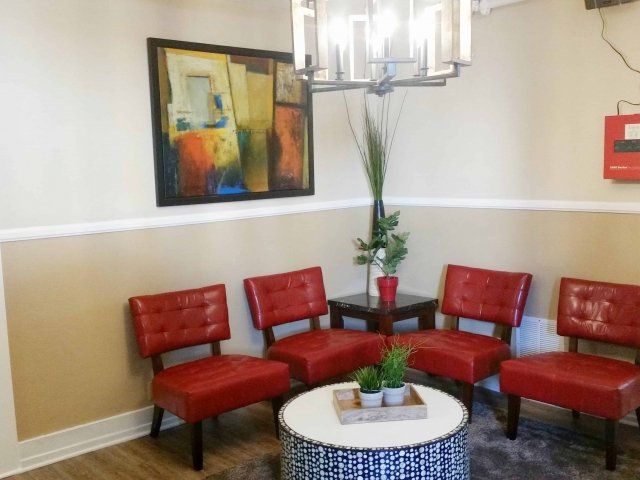 Common area with small table and red chairs in unit at 619 Living