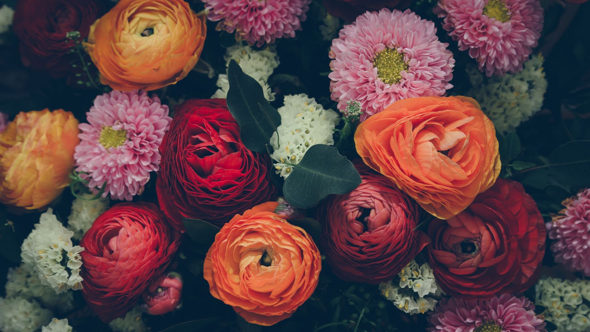 There are many different types of flowers in this bouquet.