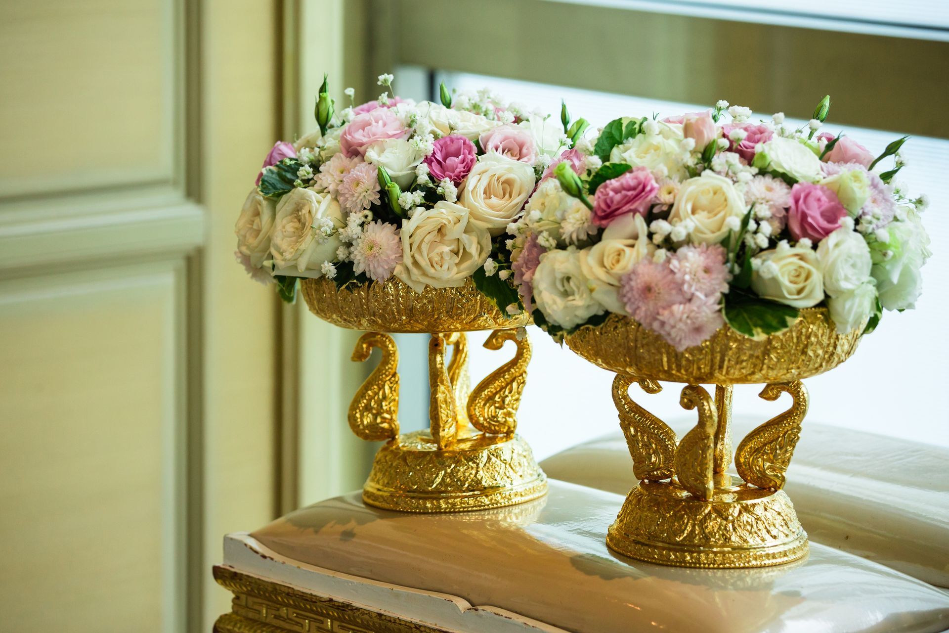Two vases filled with flowers are sitting on top of a table. Two vases filled with flowers are sitting on top of a table.