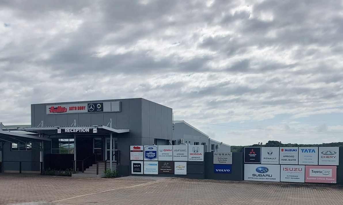 A large building with a lot of signs on the side of it.