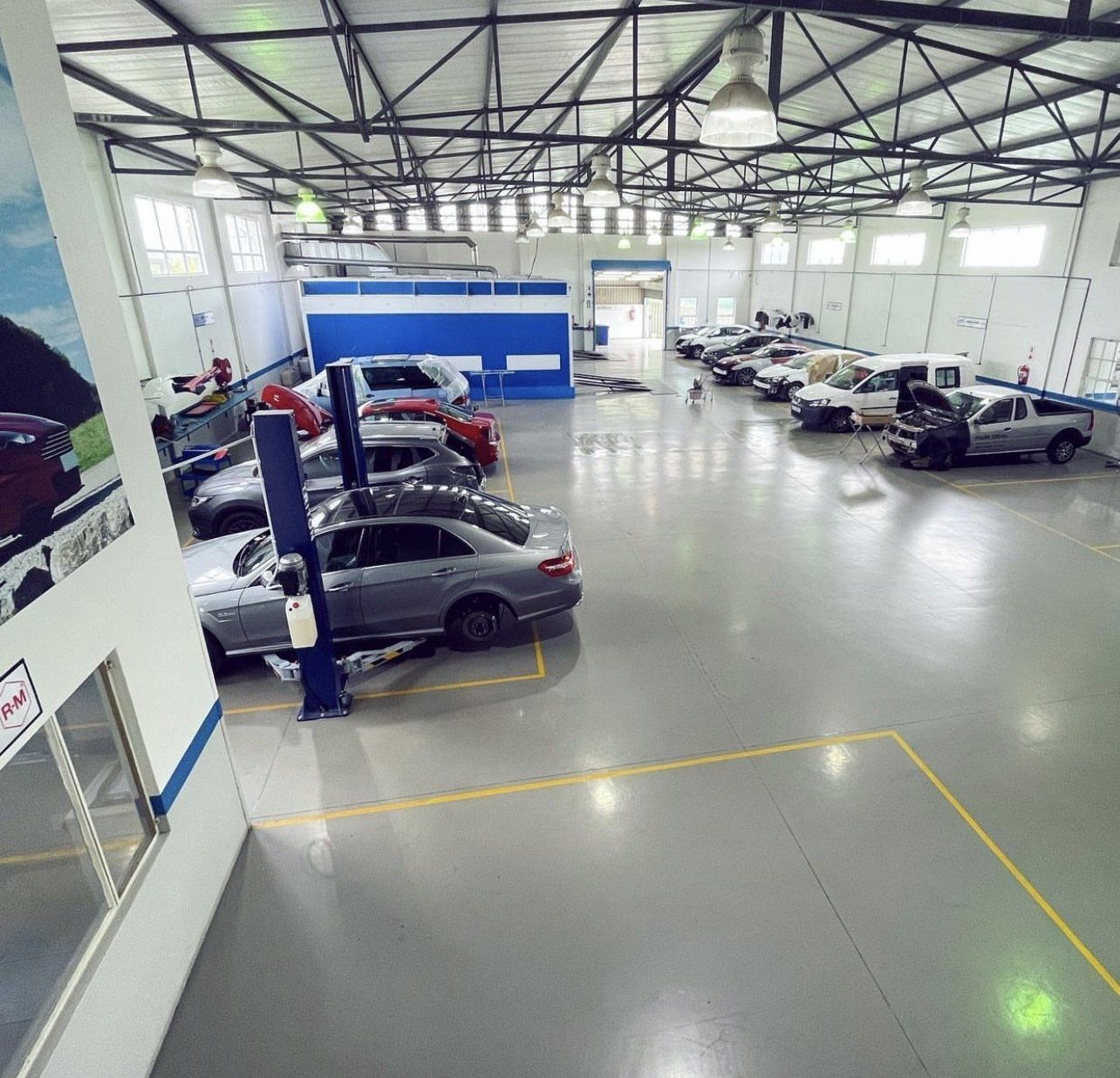 A lot of cars are parked in a garage.