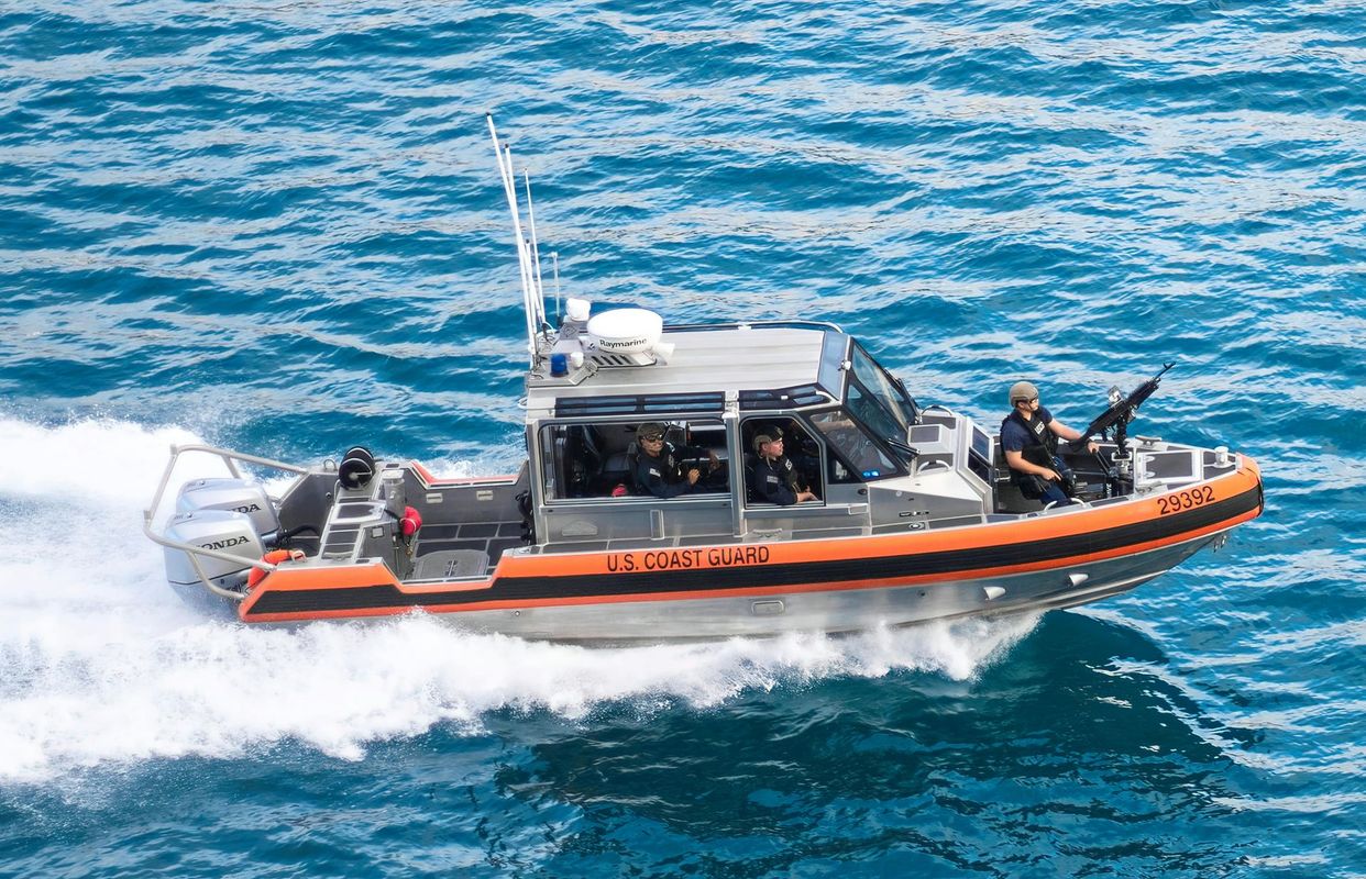 A small boat is floating on top of a body of water.