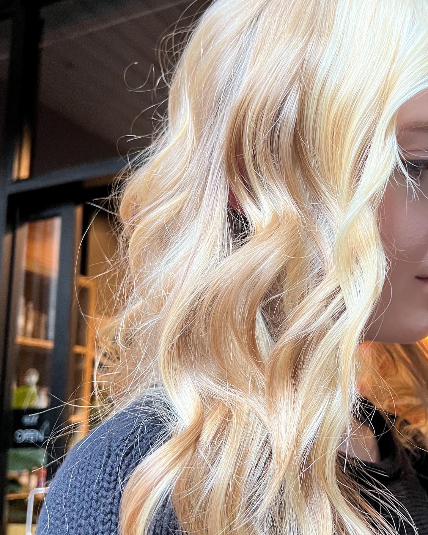 A Close Up of a Woman 's Face With Her Hair Blowing in the Wind — Energy Hair Co in Noosa Heads, QLD