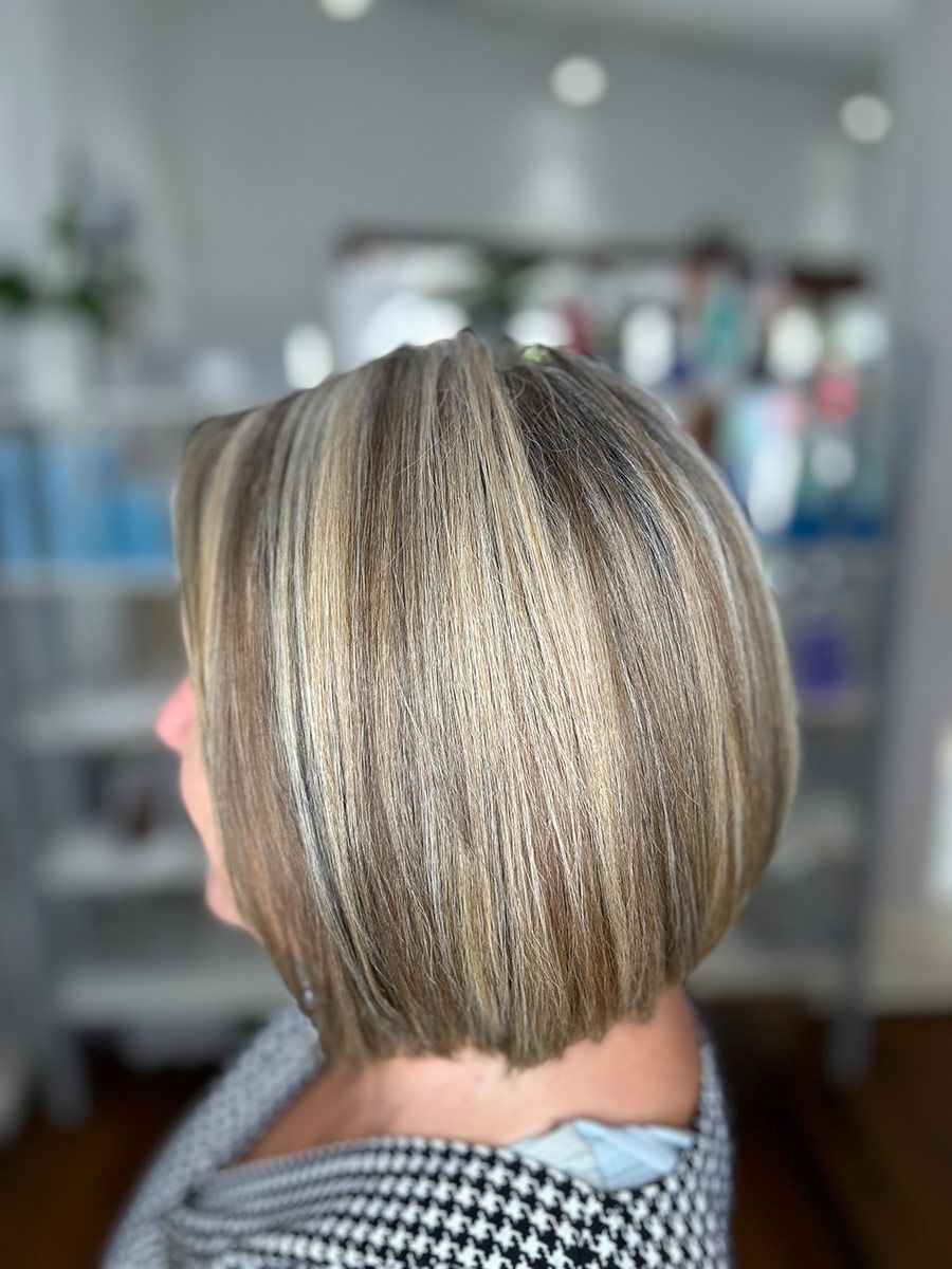 A Woman With Short Blonde Hair is Sitting in a Room — Energy Hair Co in Noosa Heads, QLD