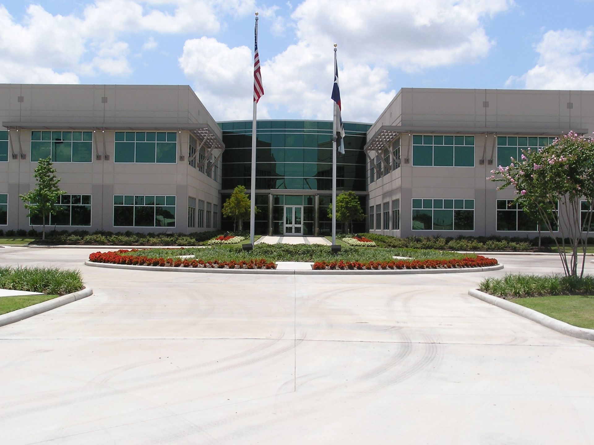 A large building with two american flags in front of it