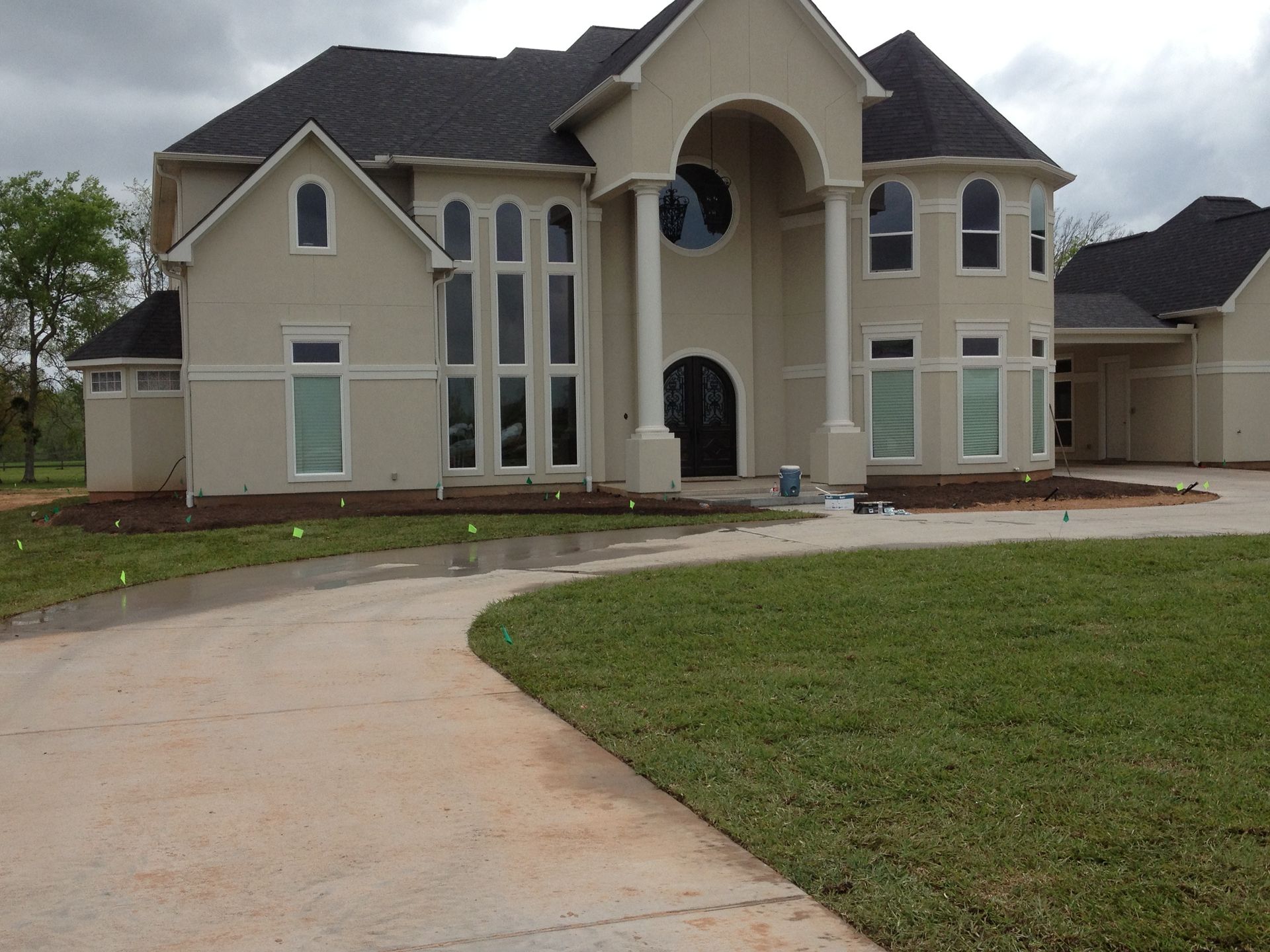 A large white house with a driveway leading to it