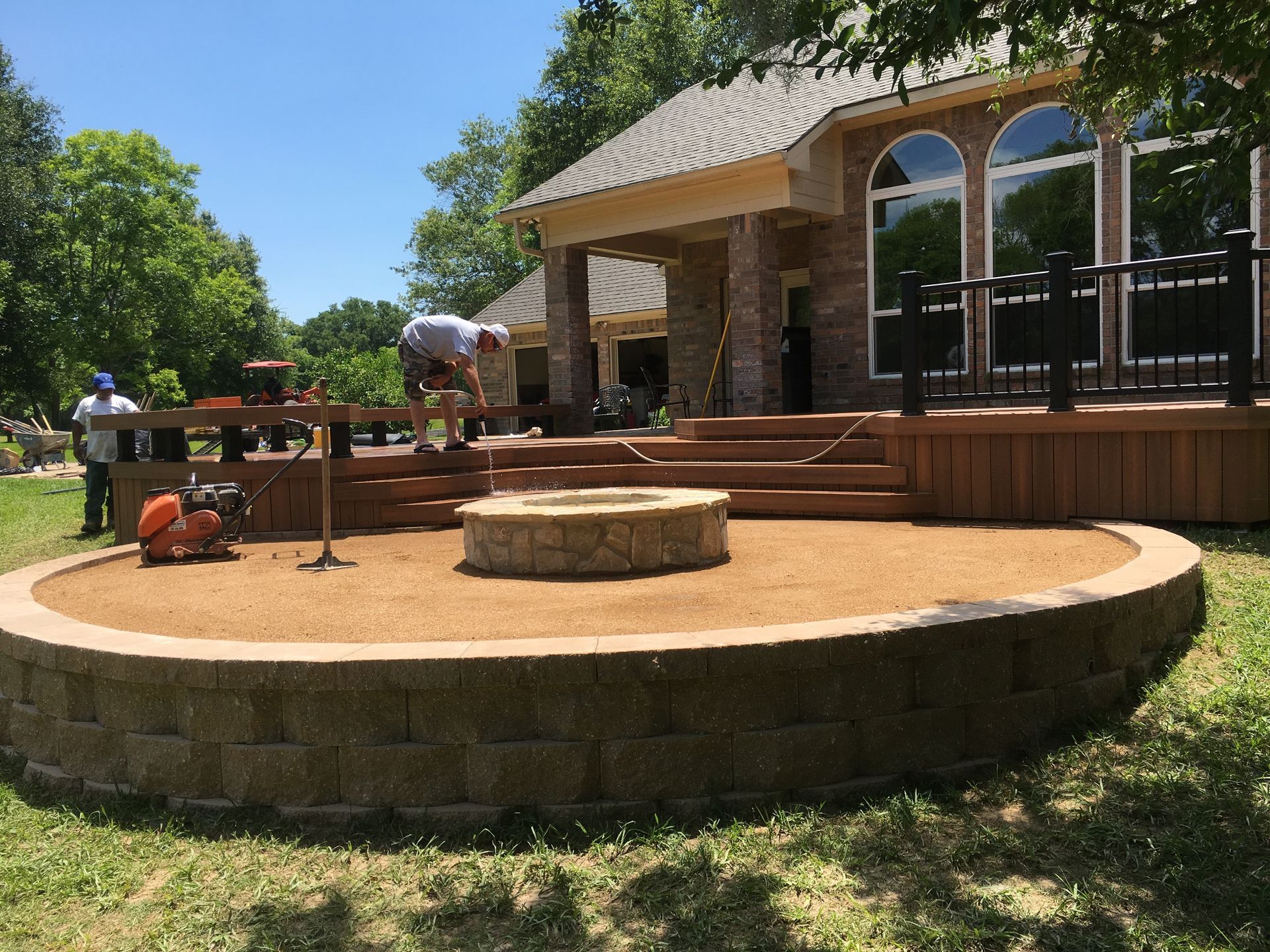 A fire pit is being built in front of a house.
