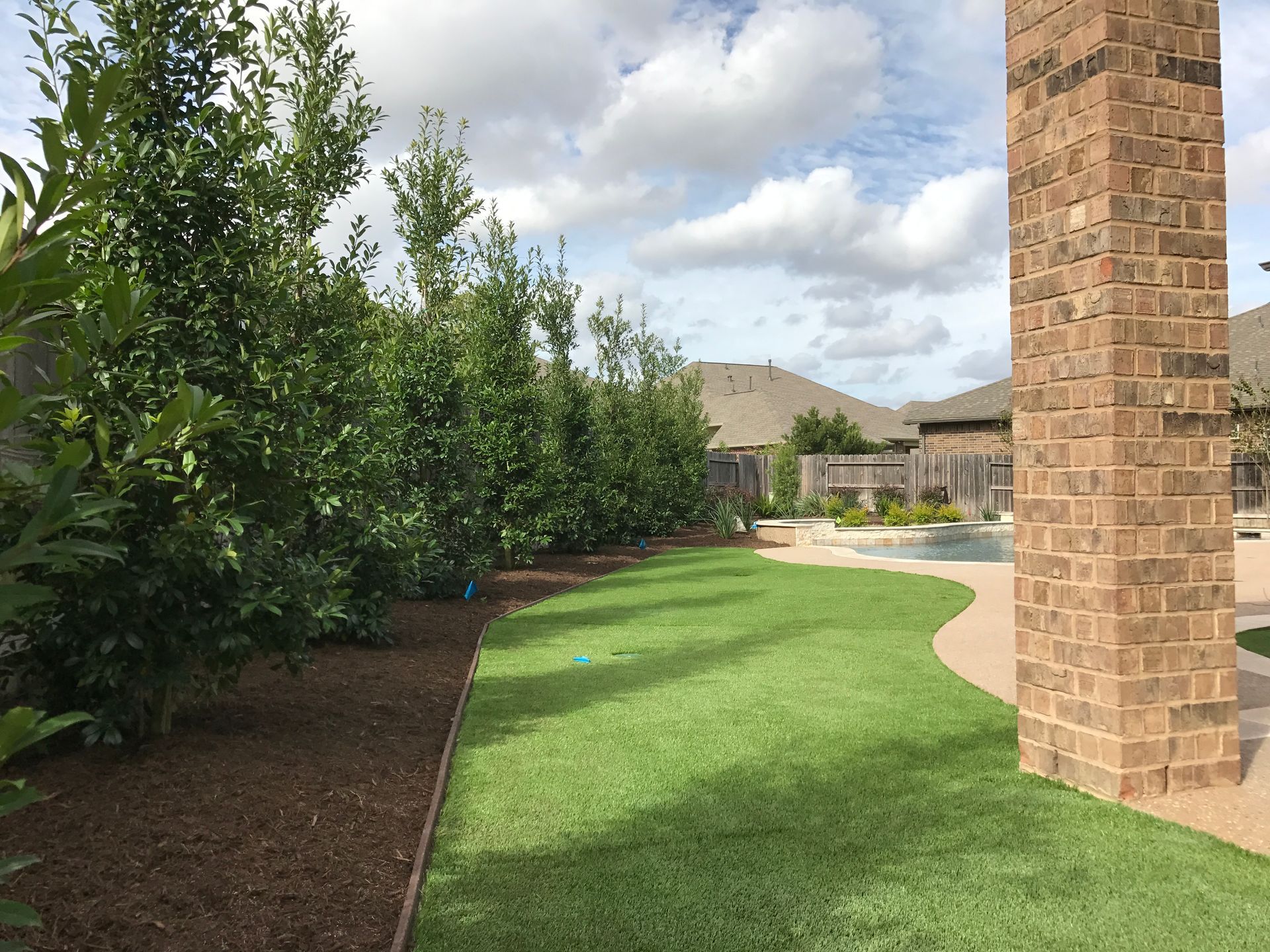 There is a brick chimney in the middle of the yard.