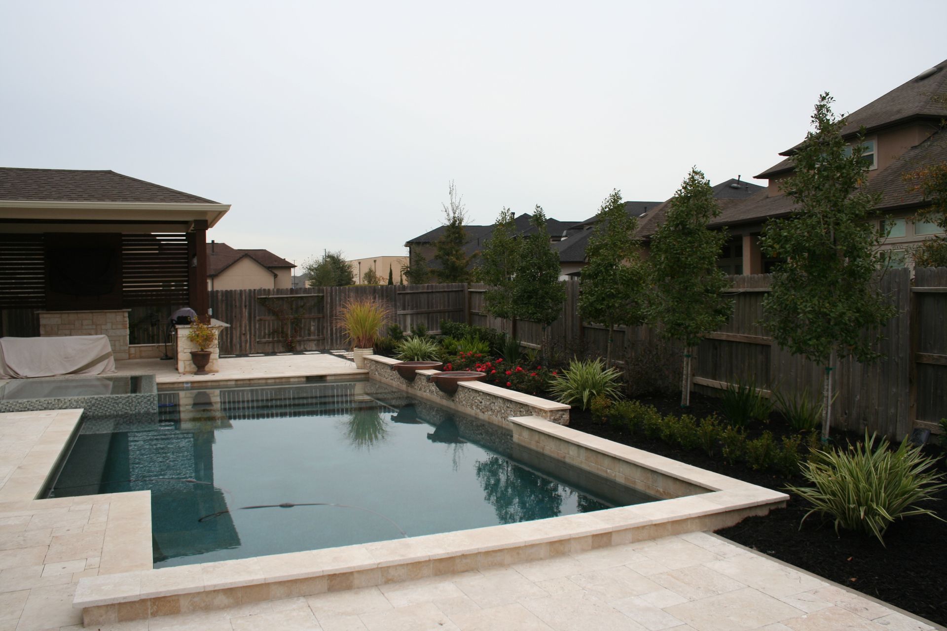 A large swimming pool in the backyard of a house
