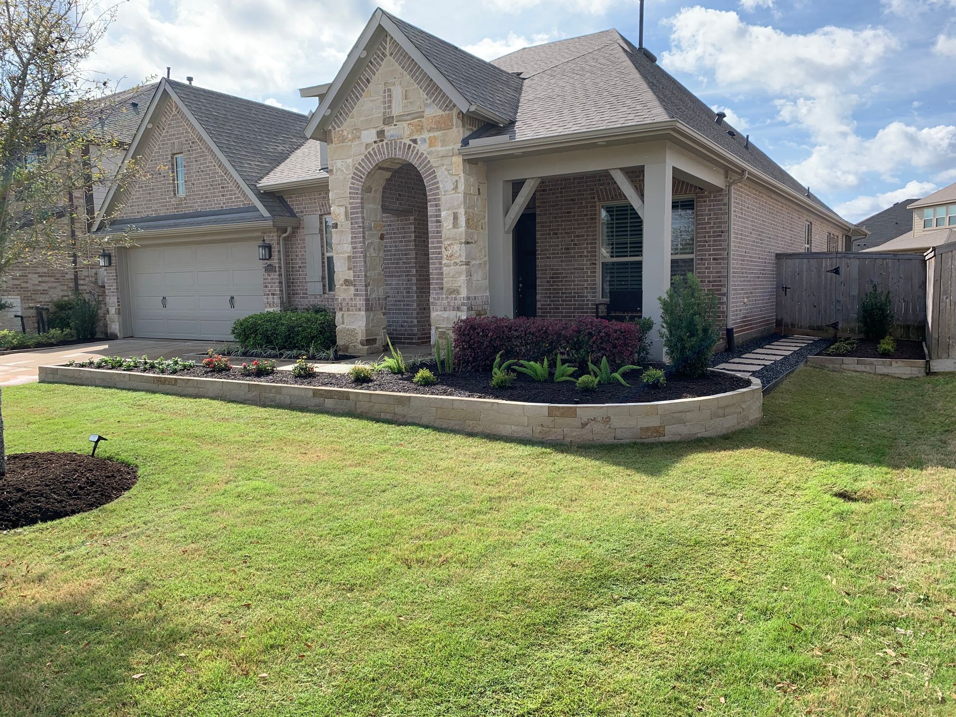 A house with a large lawn in front of it.