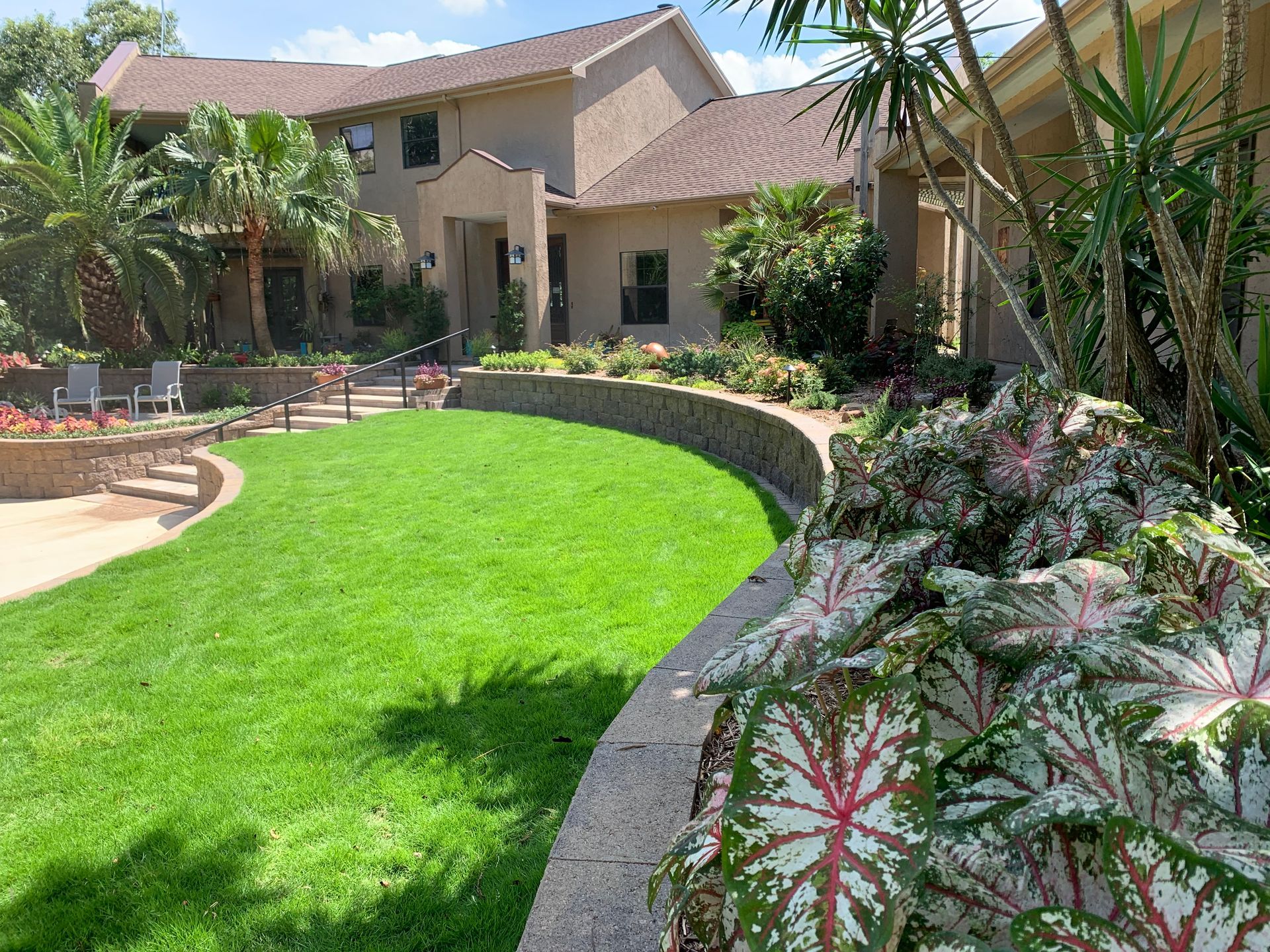 A large house with a lush green lawn in front of it.
