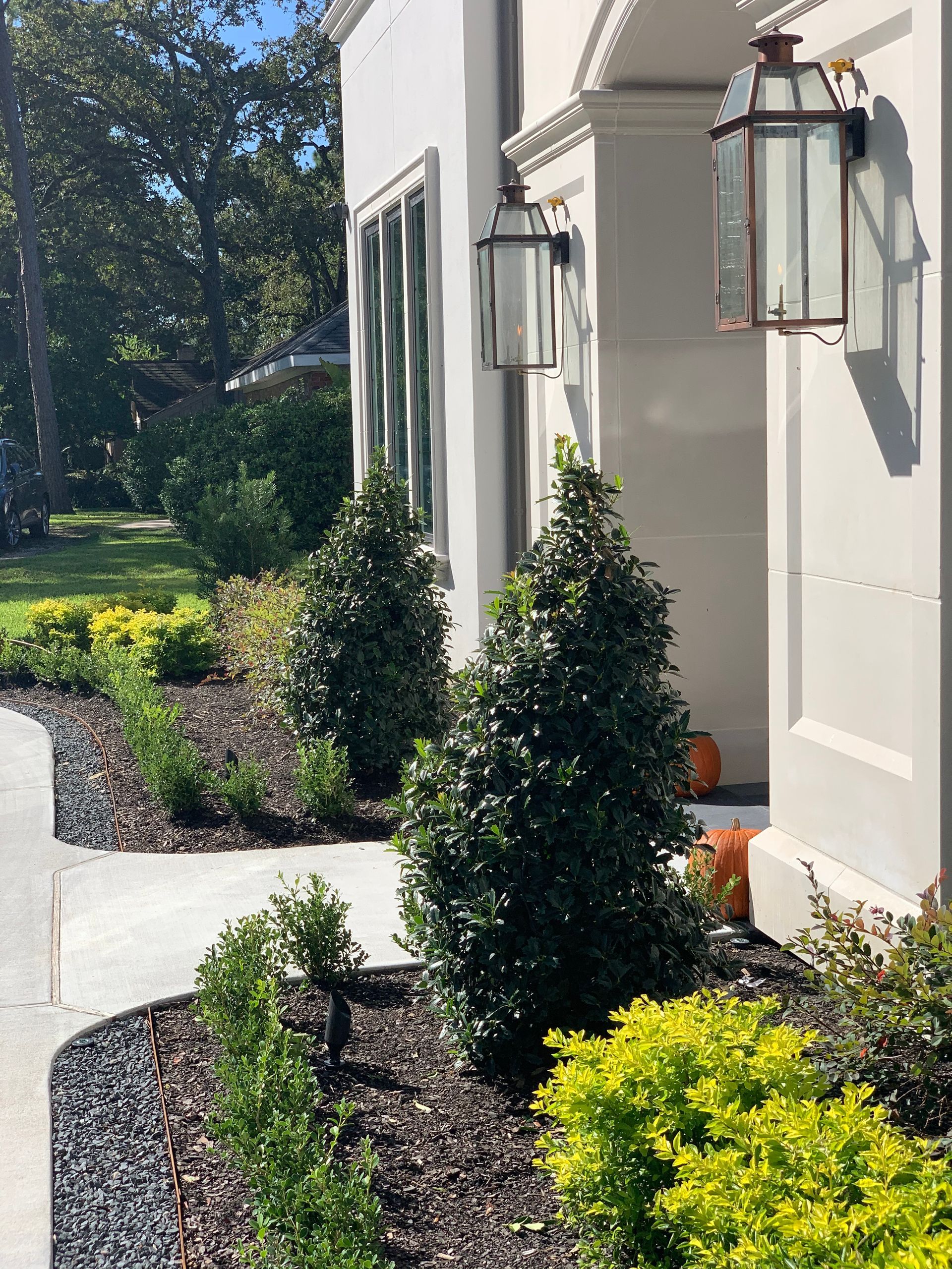 A white house with a lantern on the side of it