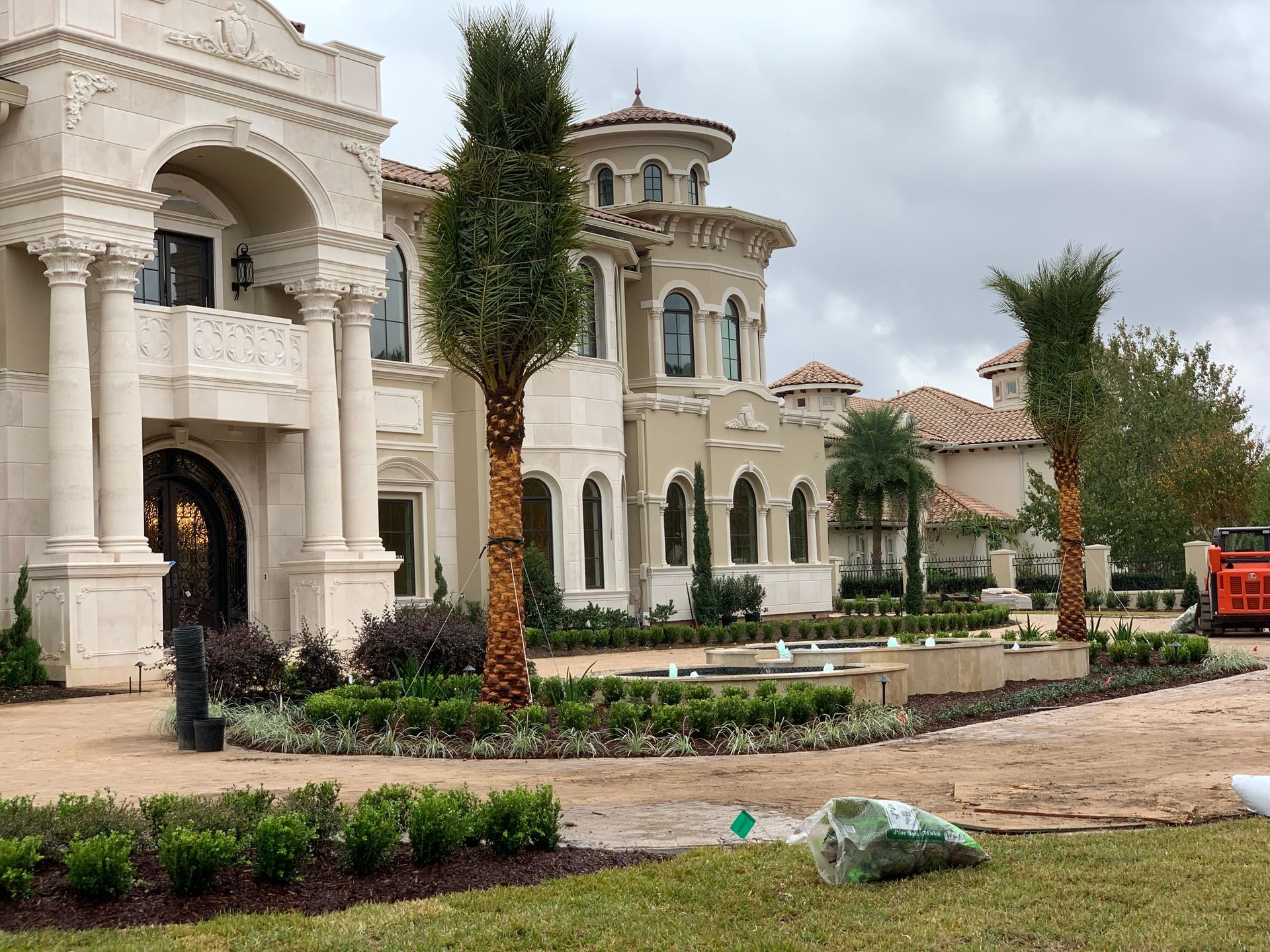 A large house with palm trees in front of it