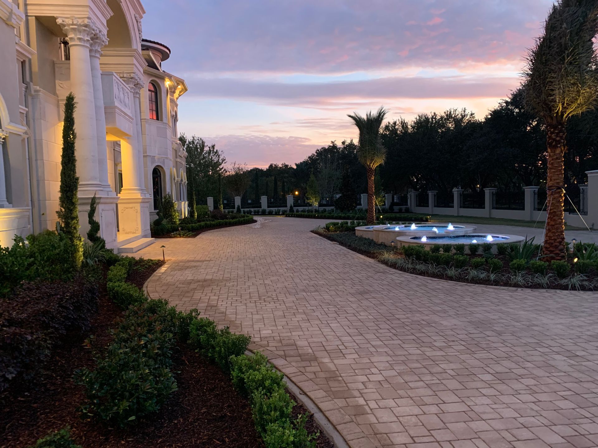 A large house with a brick driveway leading to it